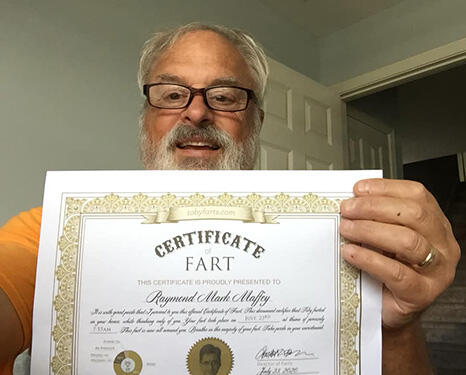 customer proudly holds certificate of fart